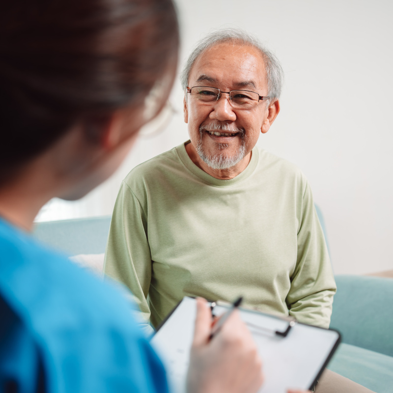 older man getting help at doctor's office